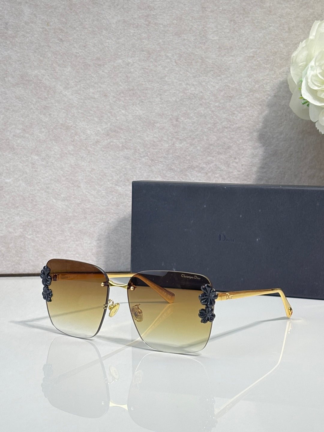 Dior sunglasses, gold frame, dark blue temples, yellow gradient lenses, floral accents