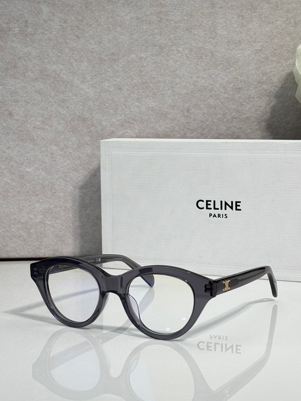 Celine round eyeglasses with black acetate frames and gold-tone logo on temple