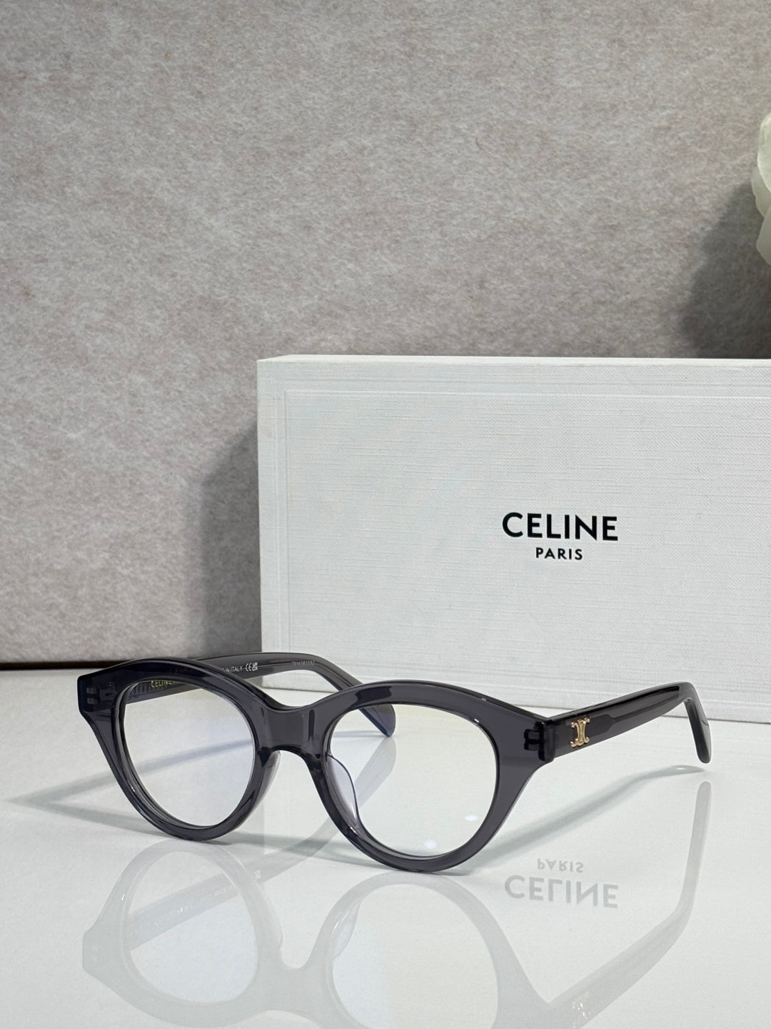 Celine round eyeglasses with black acetate frames and gold-tone logo on temple