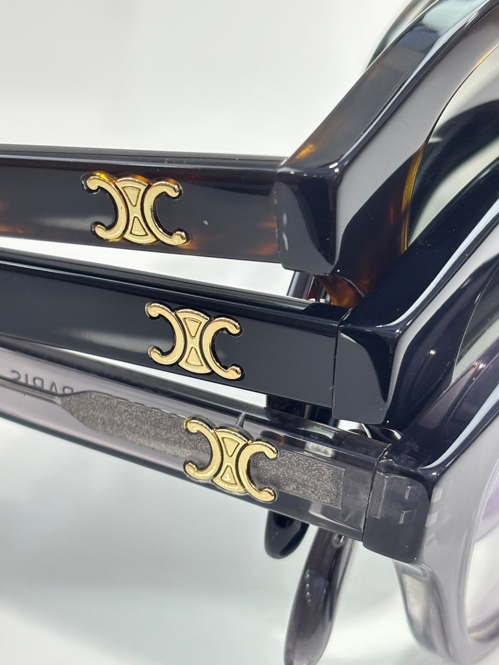 Celine temple detail with gold-tone emblem on dark acetate eyeglass frames