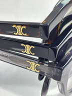 Celine temple detail with gold-tone emblem on dark acetate eyeglass frames