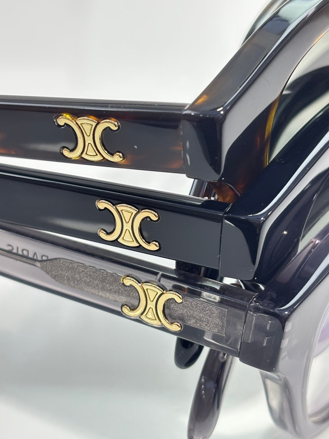 Celine temple detail with gold-tone emblem on dark acetate eyeglass frames