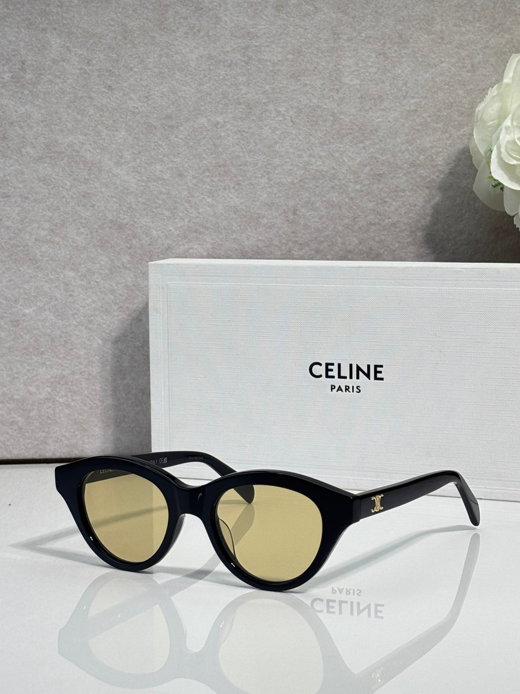 Celine sunglasses with black oval frames and light olive-tinted lenses
