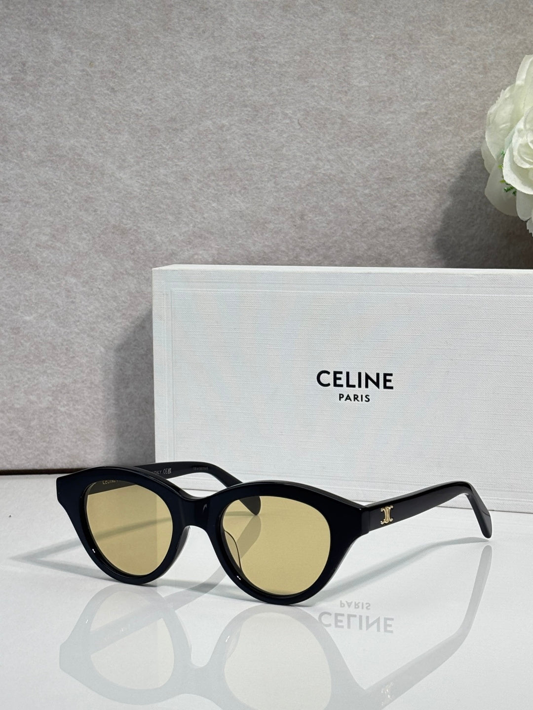 Celine sunglasses with black oval frames and light olive-tinted lenses