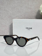 Celine sunglasses with black frames, tortoiseshell tips, and dark-tinted lenses