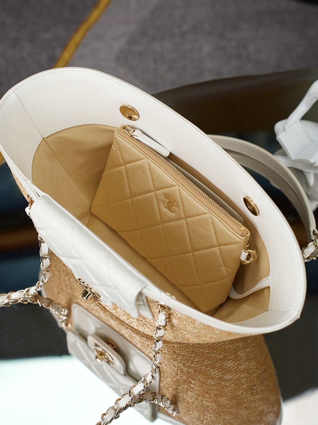 Chanel mini bag with white exterior and tan quilted interior pocket