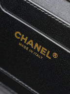 Chanel strap label reading “MADE IN ITALY” on black leather