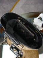 Chanel mini bag interior view with quilted black leather, gold zipper, and chain strap