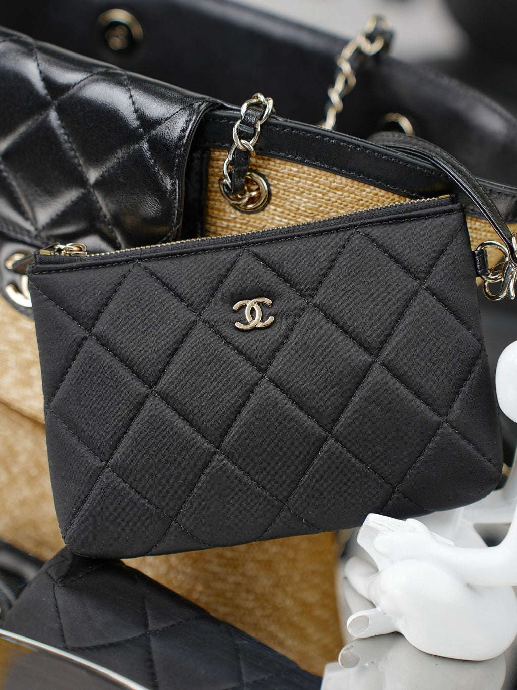 Chanel quilted black mini bag with CC logo, gold chain strap, and zipper top