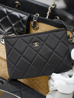 Chanel quilted black mini bag with CC logo, gold chain strap, and zipper top