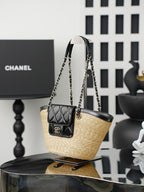 Chanel bag with woven straw body and black leather top, hanging chain handles and quilted mini pouch