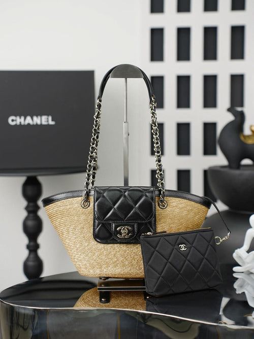 Chanel bag with woven straw base, black leather top, chain handles, and mini quilted pouch