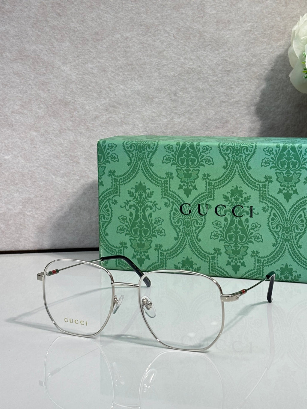 Silver eyeglasses with round clear lenses and black temple tips