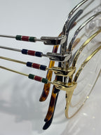 Metal eyeglass temples with red and blue striped accents and clear lenses