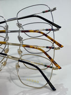 Stacked round metal eyeglass frames with black and amber acetate temples
