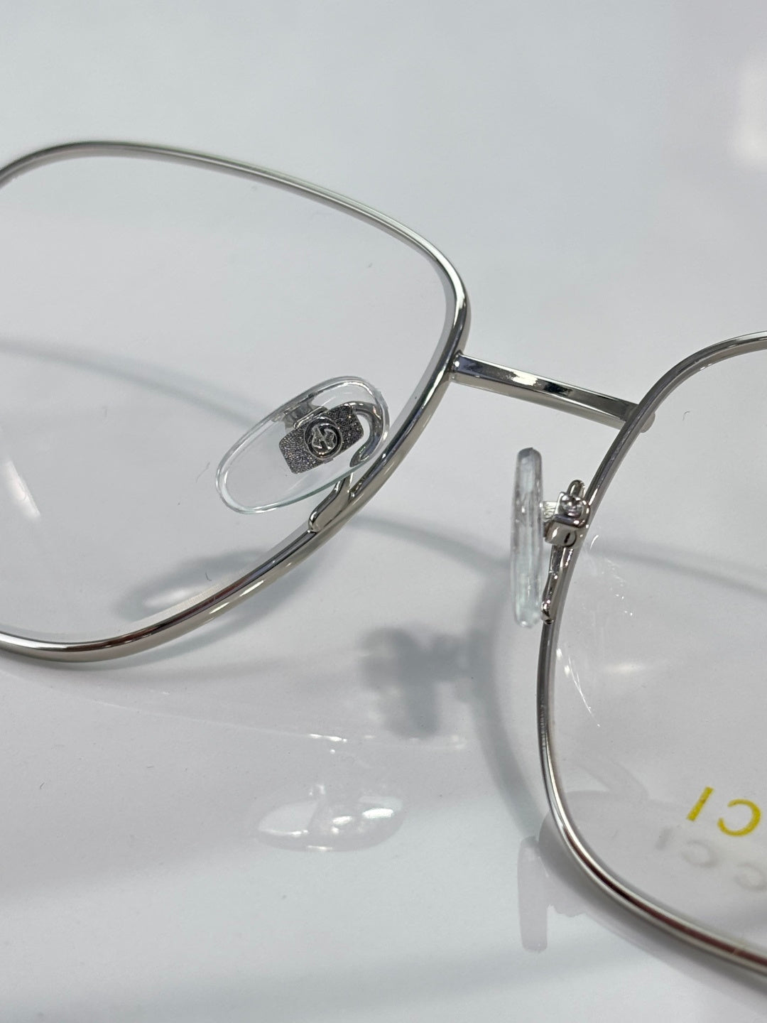 Round metal eyeglass rim with clear lens and engraved bridge detail