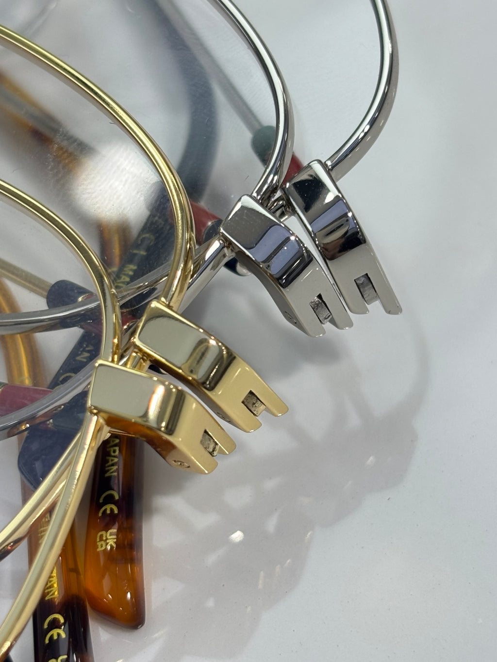 Gold and silver eyeglass hinges with rectangular metal detailing