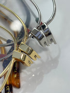 Gold and silver eyeglass hinges with rectangular metal detailing