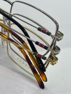 Gucci eyeglasses close-up with curved temples and multicolor stripe inlays