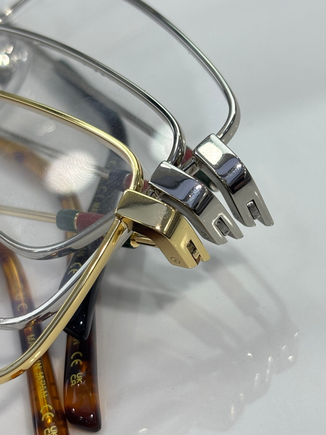 Gucci eyeglasses hinge close-up with silver and gold metal arms