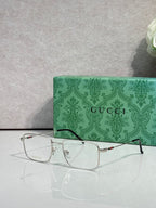 Gucci eyeglasses with silver metal rectangular frames, clear lenses, and tortoise temples