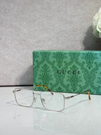 Gucci eyeglasses with silver metal rectangular frames and clear lenses, tortoise temples