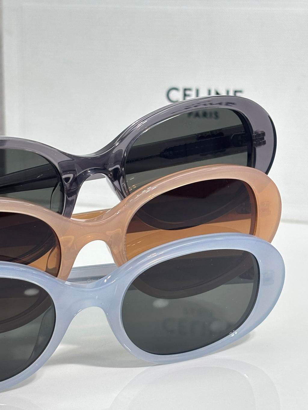 Celine sunglasses with light blue and tan frames, dark lenses, rounded cat-eye style