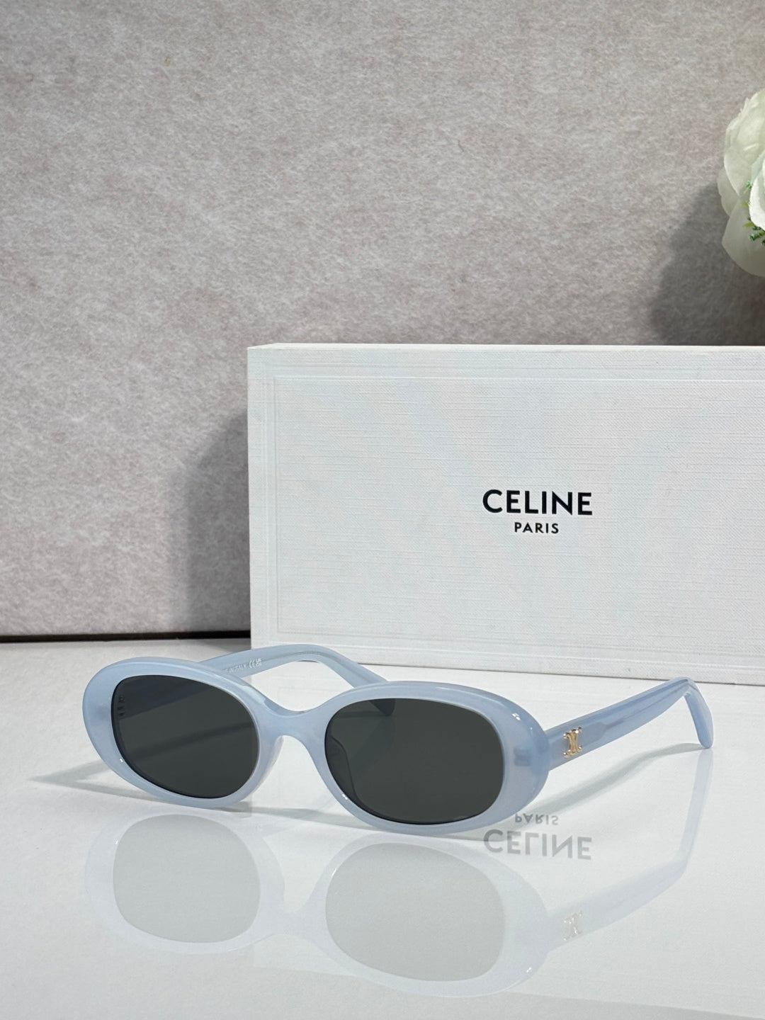 Celine sunglasses with light blue frame and dark gray oval lenses