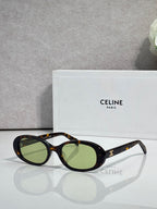 Celine sunglasses with dark frame and green-tinted oval lenses
