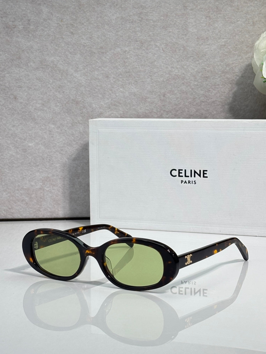 Celine sunglasses with dark frame and green-tinted oval lenses