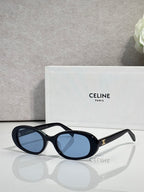 Celine sunglasses with black frame, blue oval lenses, and gold arm detail