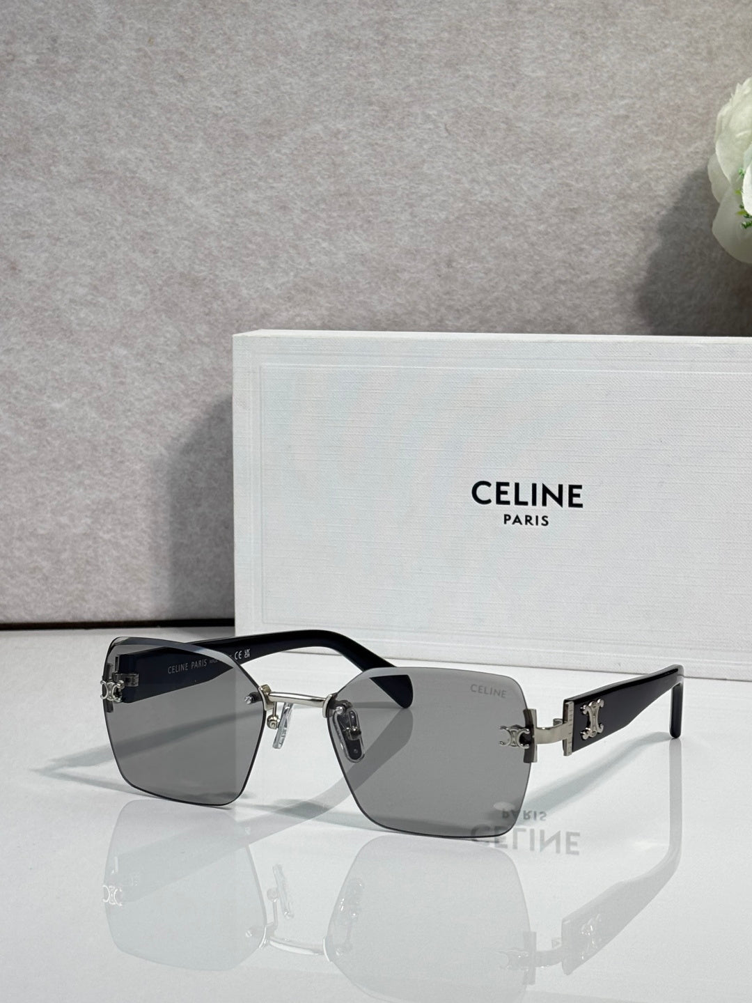 Square sunglasses with black frame and gray gradient lenses, silver logo hardware