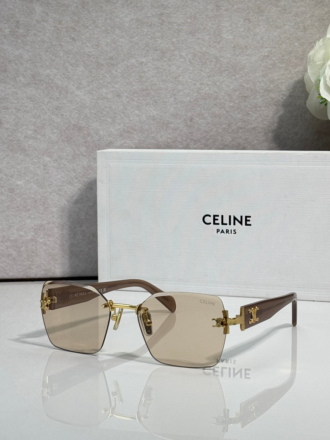 Square sunglasses with brown frame and tan gradient lenses, gold logo hardware