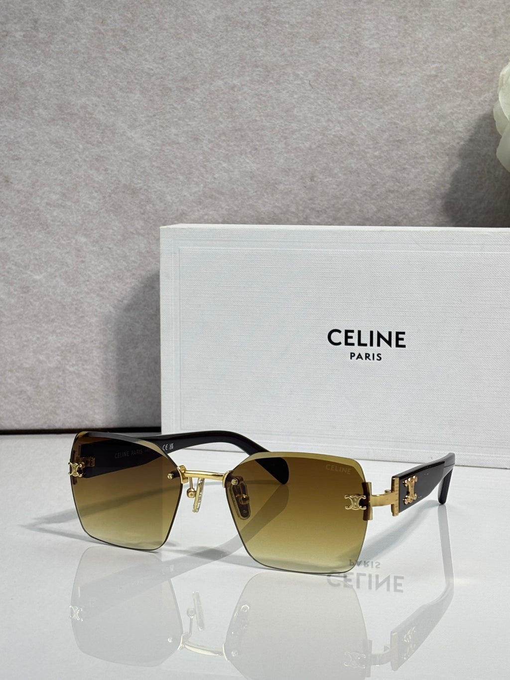 Square sunglasses with black frame and olive gradient lenses, gold logo hardware