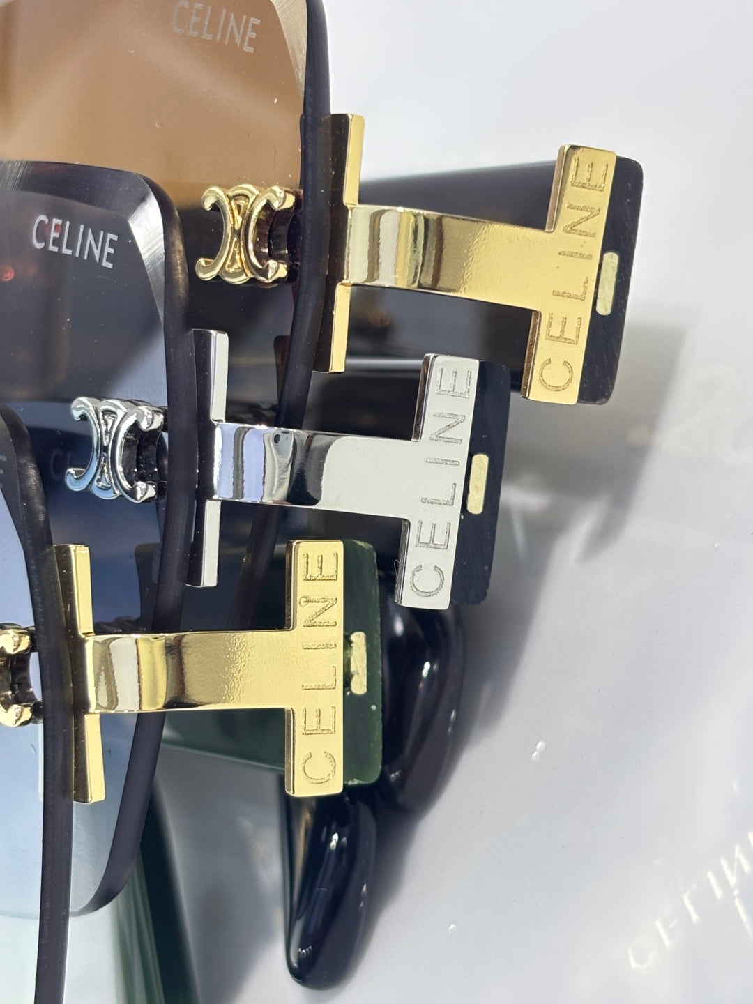 Sunglasses close-up with stacked frames, gold and silver hardware, CELINE branding