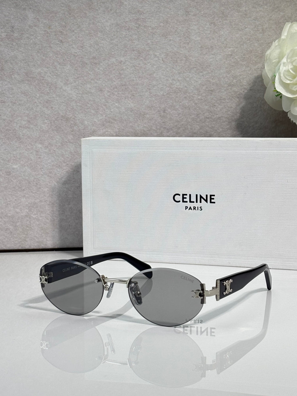 Celine round sunglasses with gray lenses and black frame arms with gold accents