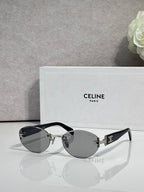 Celine round sunglasses with gray lenses and black frame arms with gold accents
