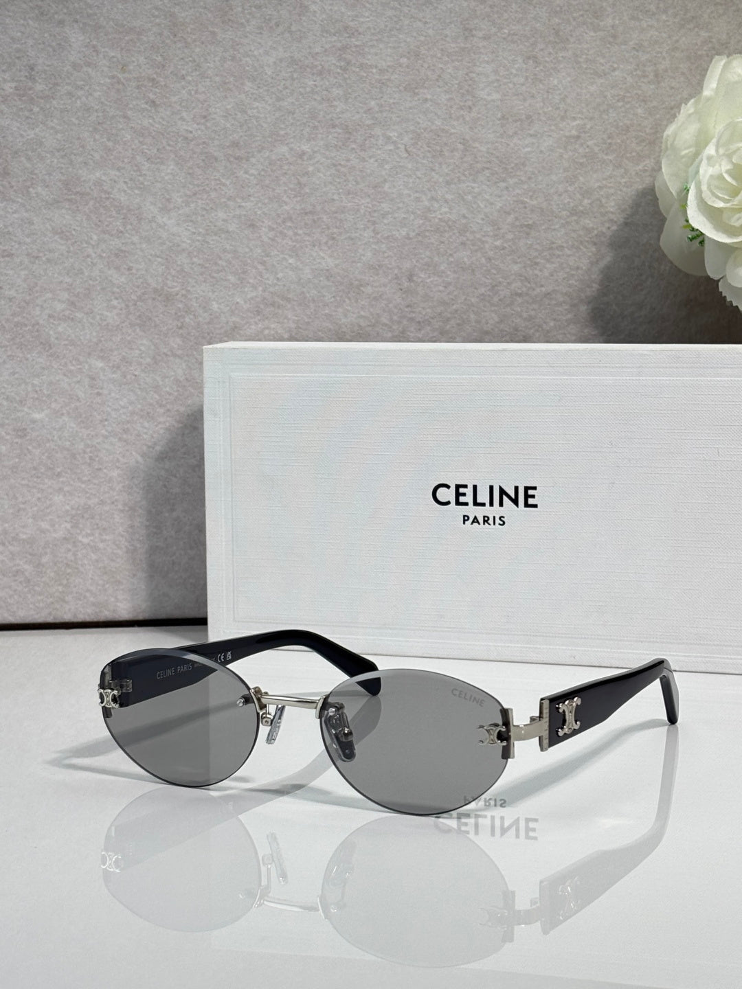 Celine round sunglasses with gray lenses and black frame arms with gold accents