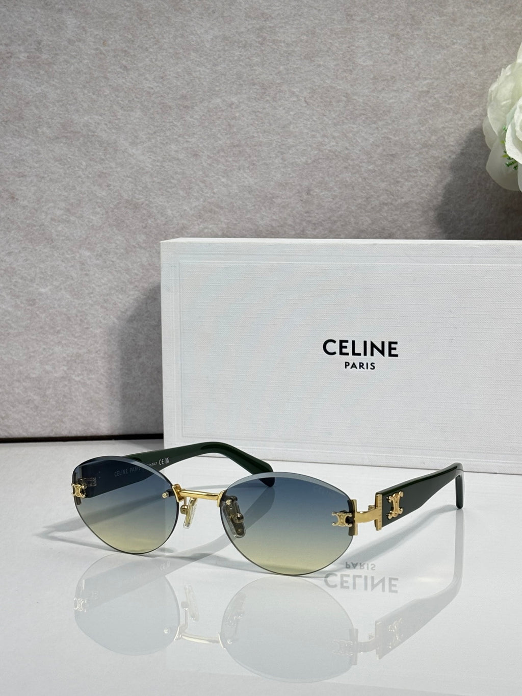 Celine round sunglasses with gold hardware, blue-tinted lenses, and black arms