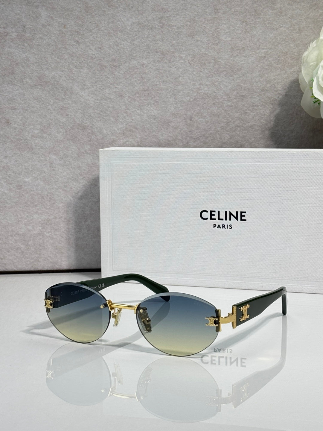 Celine round sunglasses with gold hardware, blue-tinted lenses, and black arms