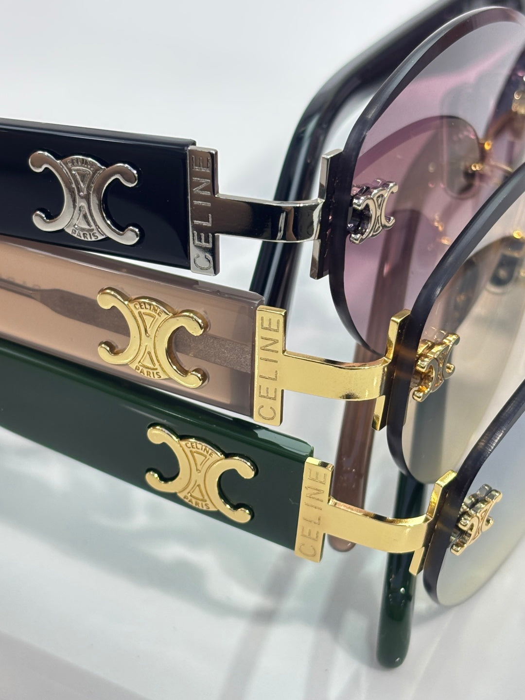 Celine sunglasses with gold trims and dark frame, featuring stacked lens panels