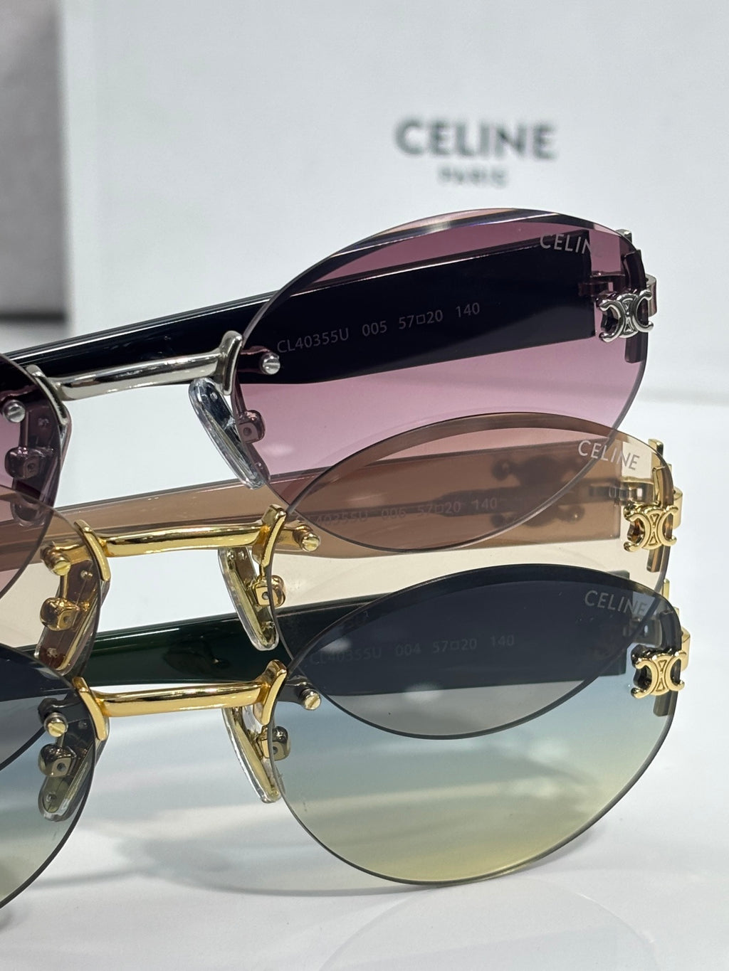Celine sunglasses with purple-tinted lens and gold metal frame, angled view