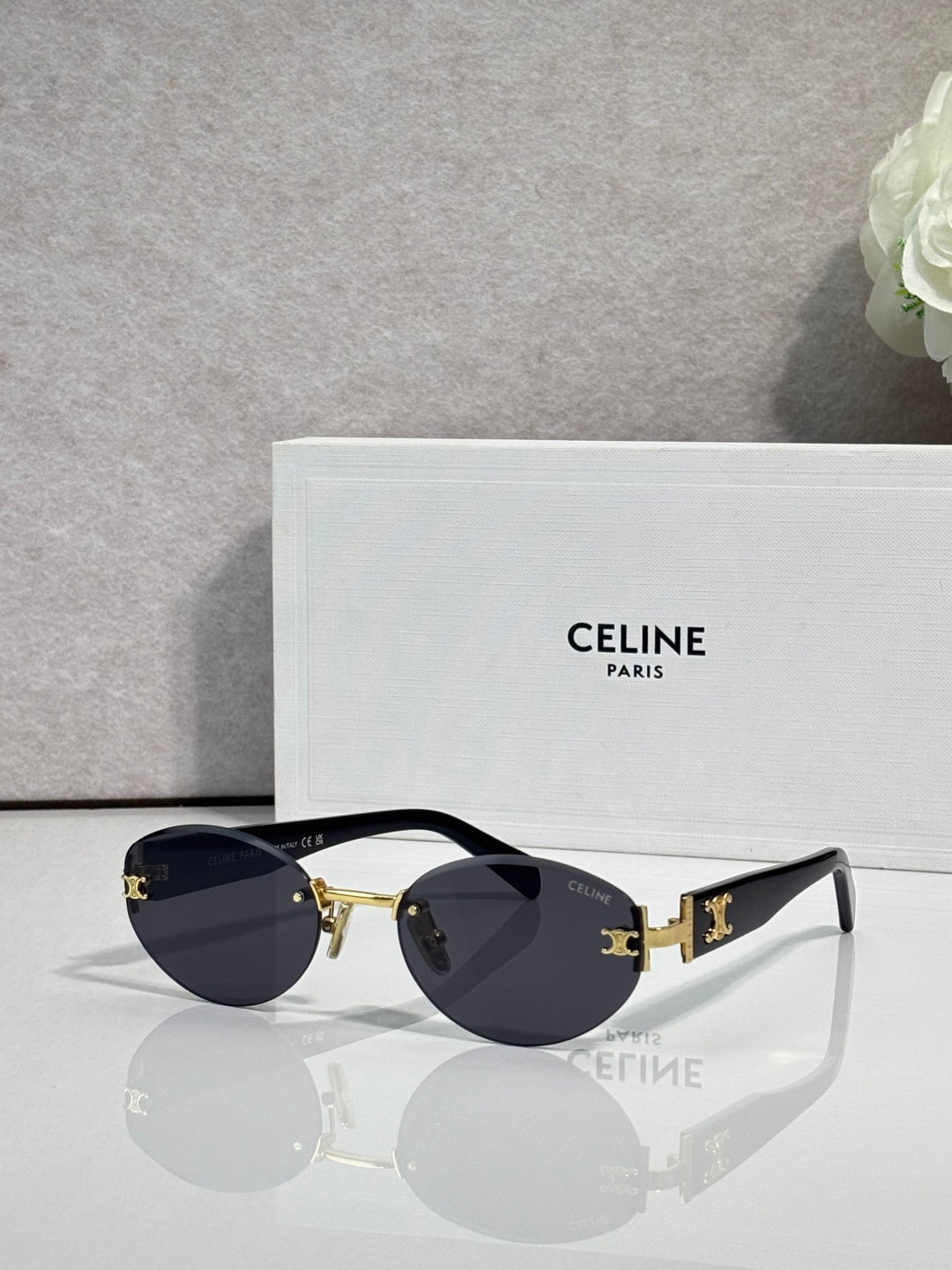 Celine round sunglasses with gold hardware, dark lenses, and black arms