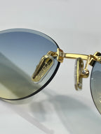 Celine sunglasses close-up of gold hinge and round blue-lens frame