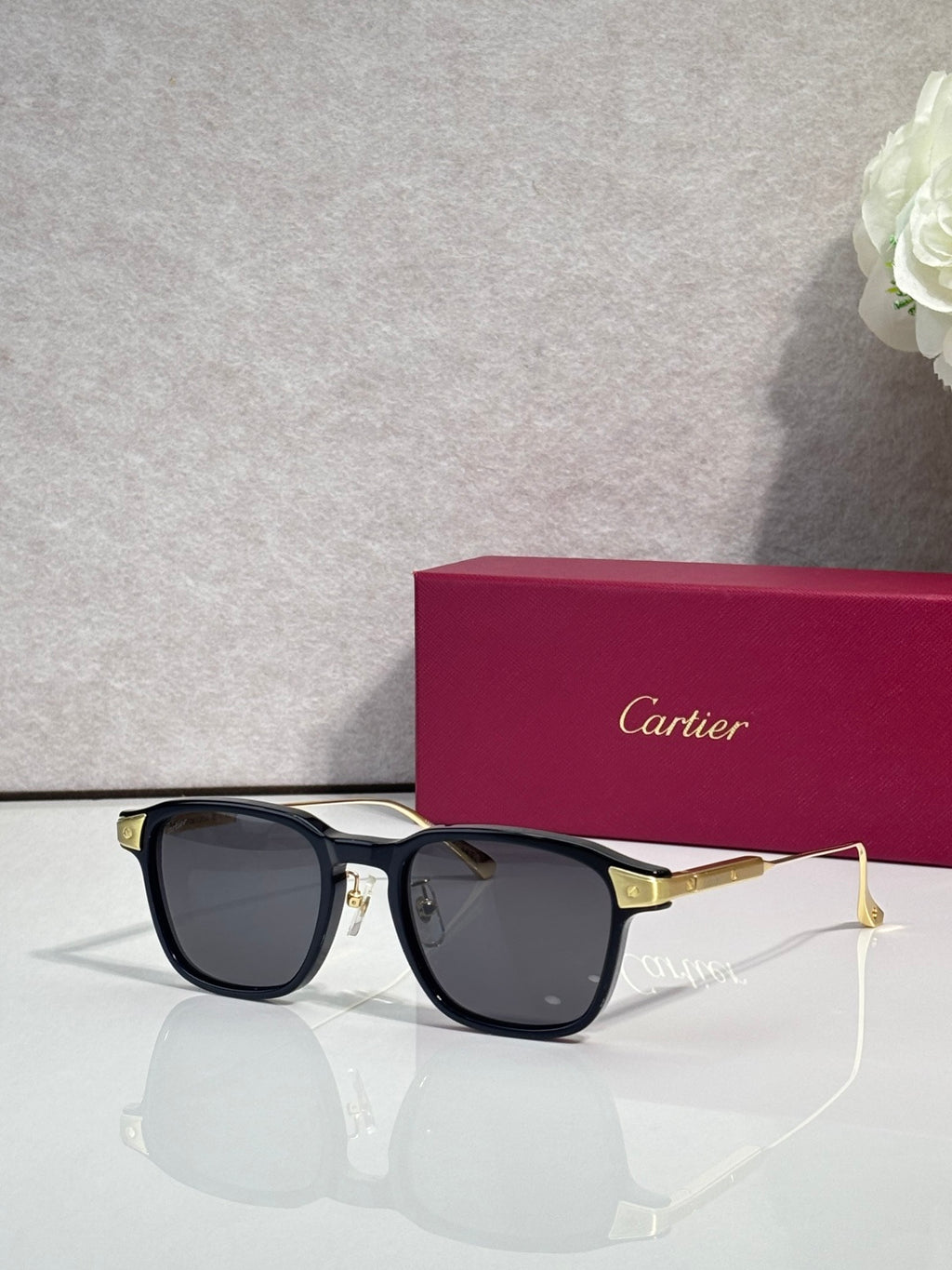 Cartier eyeglasses with black frames, dark lenses, and gold-tone arms