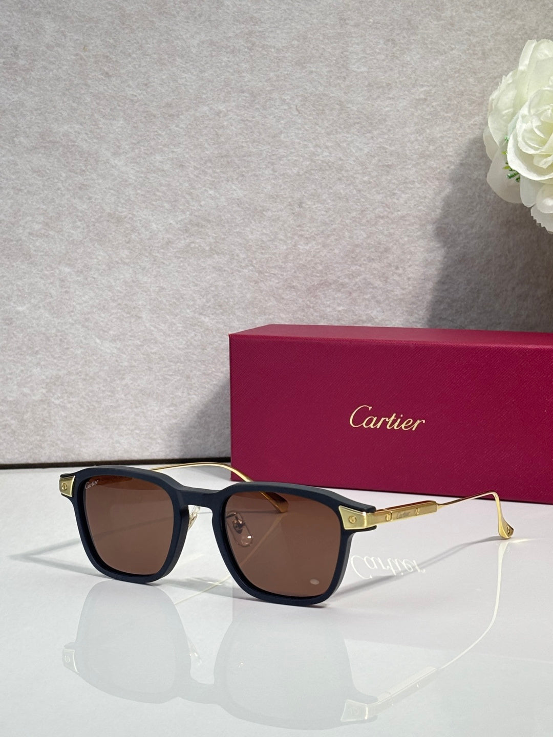 Cartier eyeglasses with black frames and brown tinted lenses