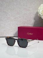 Cartier eyeglasses with black frames and dark gray tinted lenses