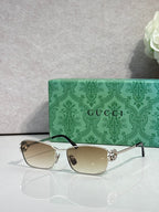 Gucci glasses with gold-tone frame and beige gradient lenses.