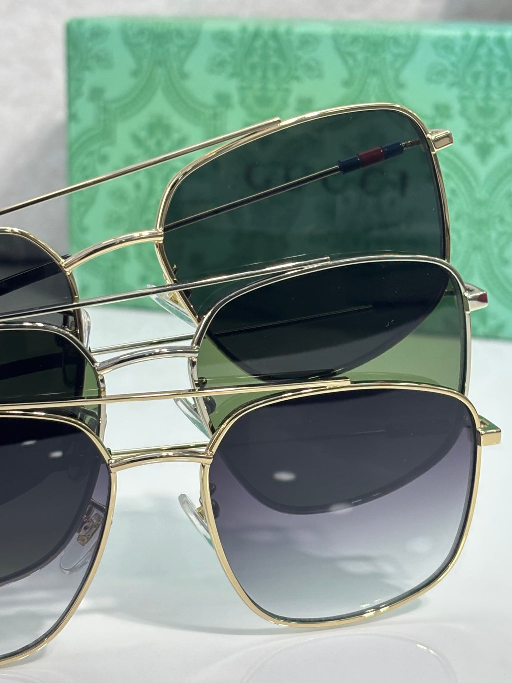 Sunglasses with gold frames and dark lenses, angled side view