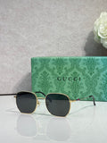 Gold-tone square sunglasses with dark lenses and green temples